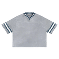 Boxy striped RAREBINO soccer jersey with blue, white, and black horizontal stripes, short sleeves, and team logo on front.